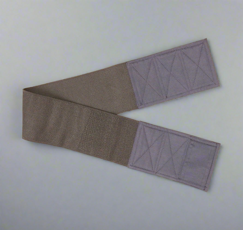 Wide elastic strap for keeping legs together for wheelchair users
